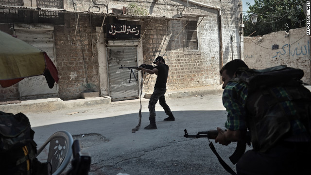 An opposition fighter fires at government forces from a street in Aleppo.