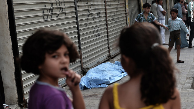 Children pass a bagged body outside a hospital in Aleppo on Thursday, August 30. 