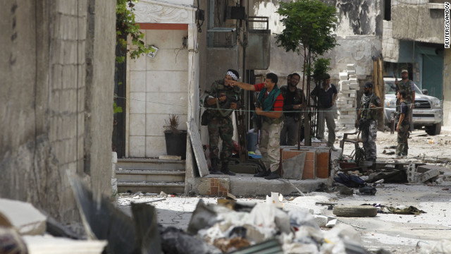 Free Syrian Army fighters take up position during clashes in the El Amreeyeh neighborhood of Aleppo.