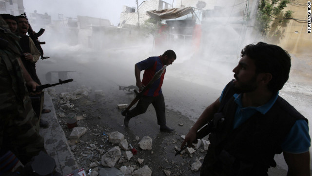 Free Syrian Army fighters run for cover after Syrian forces fired a mortar in El Amreeyeh.