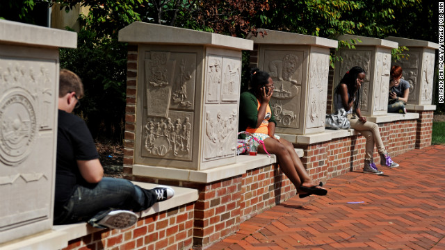 On the first day of classes, Penn State students talk on the phone and study outside the HUB, the student union center.