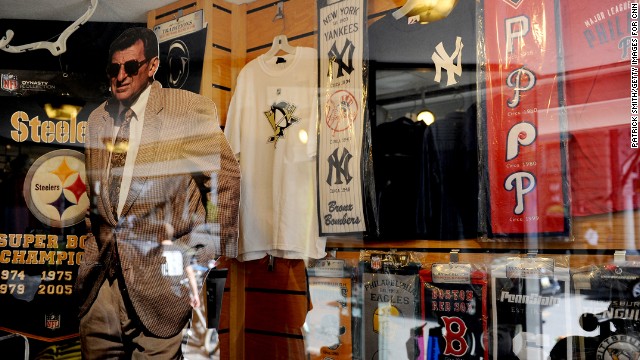 A Paterno cutout stands inside a storefront window on College Avenue.