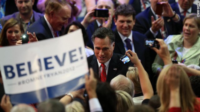 Romney greets supporters as he enters the arena Thursday.