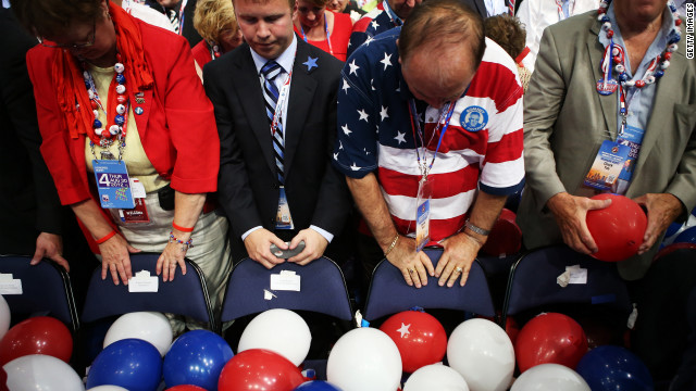 People bow their heads for the benediction to wrap up the GOP convention.