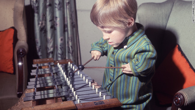 In this 1968 photo, 7-year-old Elizabeth Buckle, one of many children affected by the drug Thalidomide, plays xylophone at her home. 