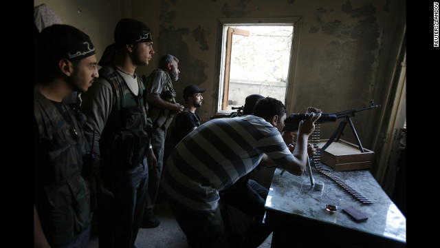 Free Syrian Army fighters take up positions in a shelled out building in the Seif El Dawla neighborhood of Aleppo on Sunday, September 2, as clashes with Syrian government forces continue.