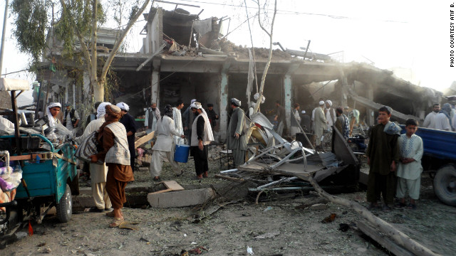 Afghans observe the scene of a recent car bombing in Kandahar. The police chief, Gen. Abdul Raziq, was among 16 people injured in the attack on August 28. Four people were killed.