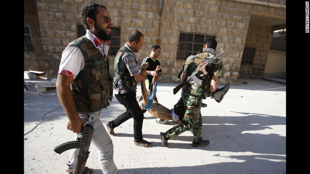 Rebels carry the body of a fellow fighter after a sniper shot him in Aleppo on Tuesday, September 4.