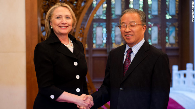 As Bill speaks, Hillary Clinton is half a world away