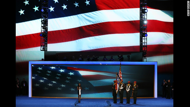 Olympic gymnast Gabby Douglas leads the Pledge of Allegiance as the West Charlotte High School ROTC presents the colors on Wednesday.