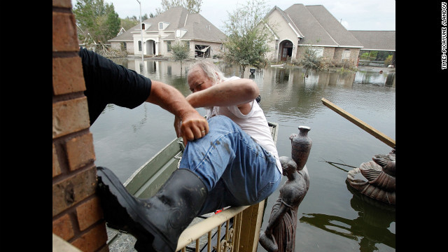 Fred Leslie is helped into a boat after retrieving items from his home, which flooded during Hurricane Isaac on September 5, 2012, in the Braithwaite neighborhood of New Orleans. Hurricane Isaac caused an estimated $2.3 billion in damage.