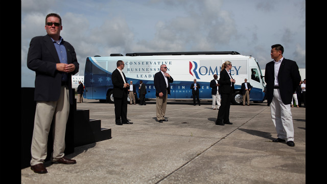 Secret Service agents guard the campaign bus of Republican presidential candidate Mitt Romney during a Republican National Convention farewell rally on Friday, August 31, in Lakeland, Florida. 