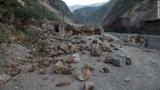 Fallen rocks block a road in Yiliang.