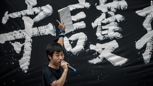 A student addresses a crowd in front of government headquarters in
 Hong Kong on Friday, September 7 during a protest against plans to 
introduce Chinese patriotism classes.