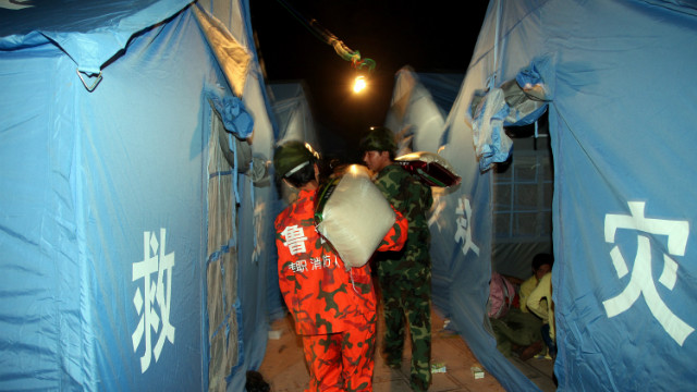 Rescuers unload supplies at an emergency relief center in Yiliang on September 8.