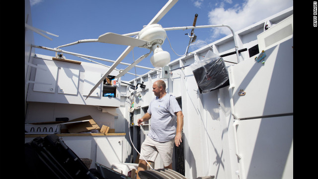 Danny Fallon of Brooklyn inspects the damage in his rental cabana.