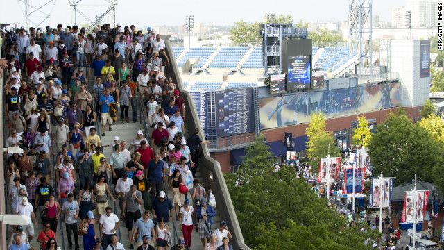 Spectators evacuate the Arthur Ashe Stadium during a semifinal match at the U.S. Open due to severe weather in the area. 