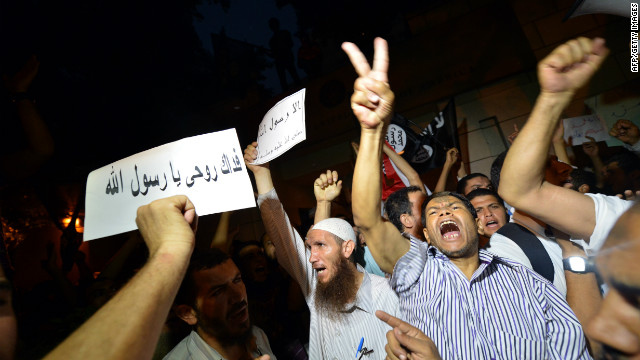 Egyptian riot police stand guard as protesters climb down from the wall.