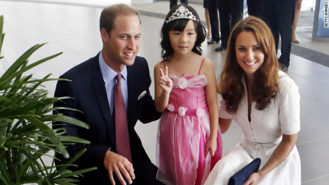 Prince William and Catherine pose with 4-year-old Maeve Low as they tour the Rolls-Royce Seletar Campus during the Diamond Jubilee tour at Seletar Aerospace Park on Wednesday, September 12, the second day of their Diamond Jubilee tour in Singapore.