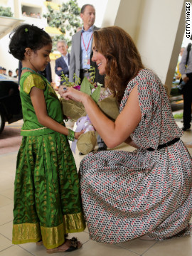 A young girl gives flowers to Catherine on Wednesday.