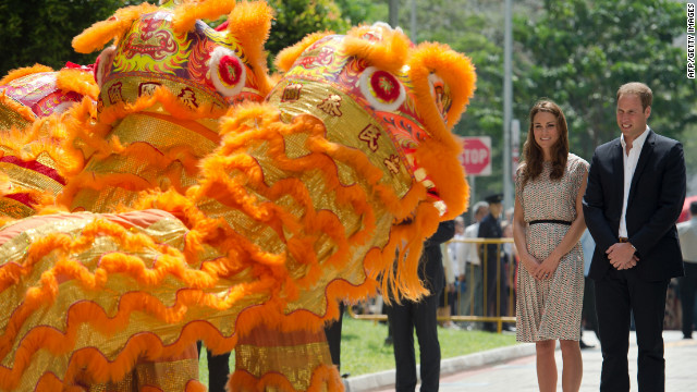 Prince William, right, and wife Catherine are welcomed by a lion dance performance on Wednesday.
