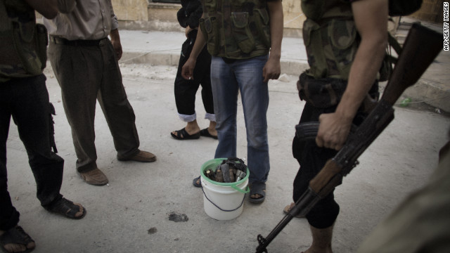 Syrian rebels gather around a bucket of mortars while fighting with scarce ammunition in the Saif al-Dawla neighborhood of Aleppo on Wednesday.