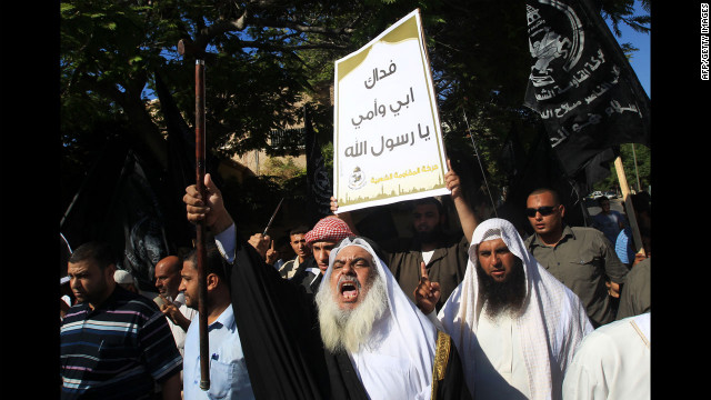 A Palestinian man holds a placard praising Islam's prophet Mohammed during a demonstration against the film on Wednesday in front of the United Nations headquarters in Gaza City.