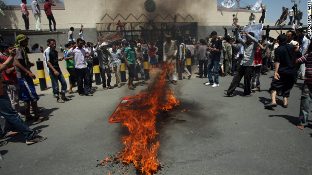 Yemeni protesters gather around a fire Thursday during a demonstration outside the U.S. Embassy in the capital of Sanaa. Yemeni forces fired warning shots to disperse the thousands of protesters approaching the main gate of the mission.
