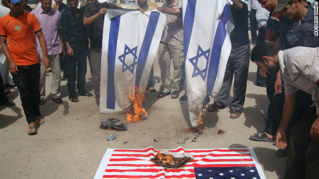 Iraqi protesters burn Israeli and U.S. flags during a protest Thursday. The U.S. ambassador to Libya, J. Christopher Stevens, and three others were killed during a protest outside the U.S. Consulate in Benghazi, Libya, on Tuesday.