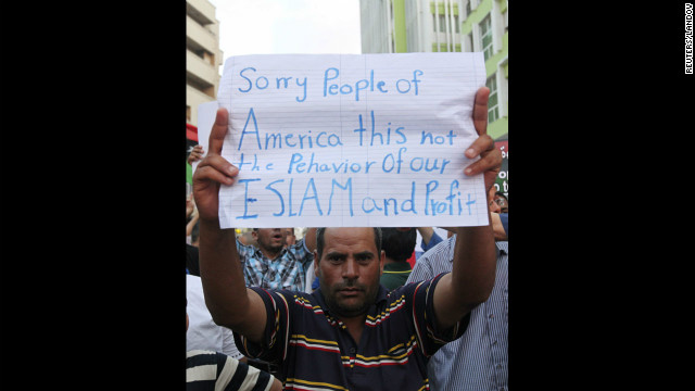 A demonstrator in Benghazi, Libya, on Wednesday, September 12, holds a message during a rally to condemn the killers of the U.S. ambassador to Libya, Chris Stevens, and three others during the attack on the U.S. Consulate. <a href='http://www.cnn.com/2012/09/11/middleeast/gallery/cairo-embassy/index.html'>Photos: Protesters storm U.S. Embassy buildings</a>