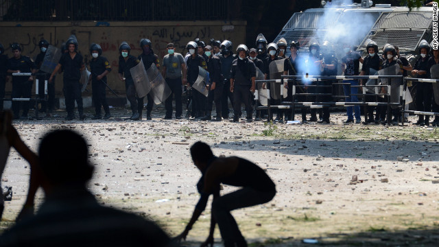 An Egyptian riot police officer fires tear gas toward protesters during clashes Thursday with police near the U.S. Embassy in Cairo. Muslims throughout the Middle East have been demonstrating for three days outside U.S. missions, denouncing a film deemed offensive to Islam. 