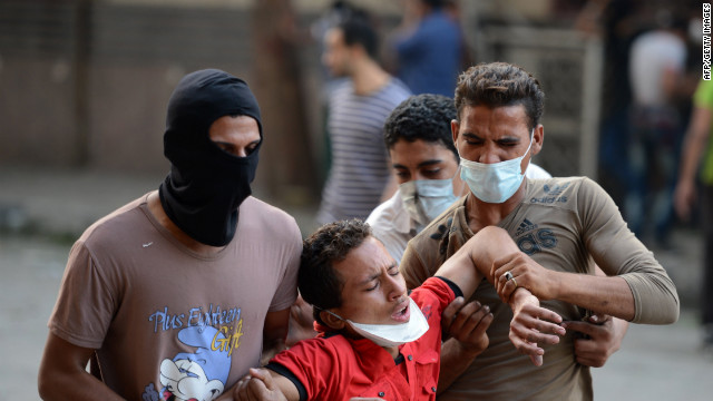 Egyptian protesters help a man who inhaled tear gas during clashes at the U.S. Embassy in Cairo on Thursday.
