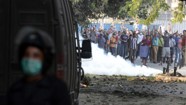 Egyptian protesters throw stones at riot police during clashes near the U.S. Embassy in Cairo on Thursday.