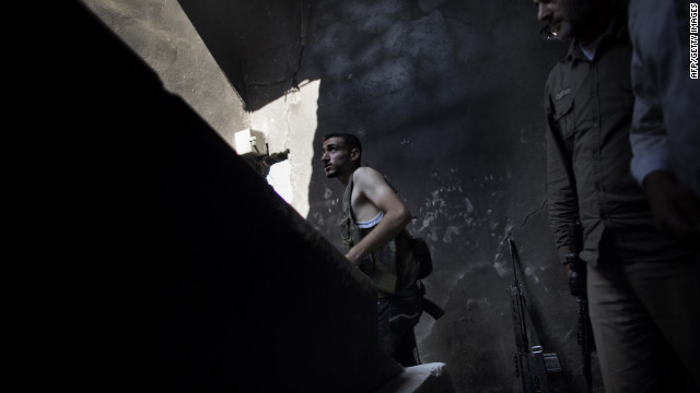 A Syrian rebel fighter takes a position in the Saif al-Dawla neighborhood of Aleppo on Wednesday, September 12.