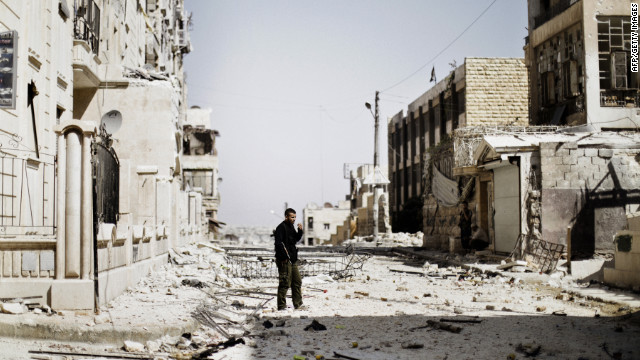 A Syrian rebel fighter patrols the Saif al-Dawla neighborhood on Wednesday.