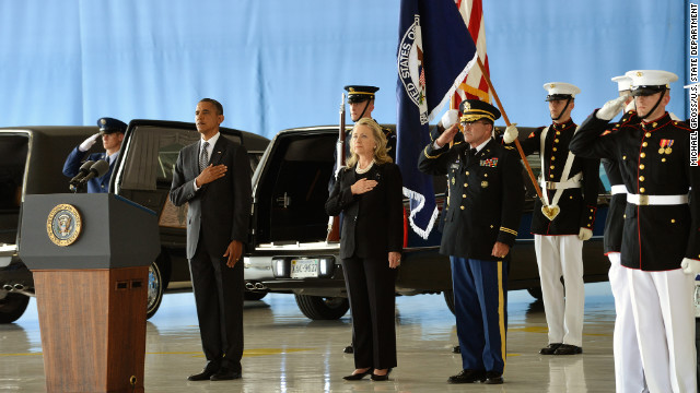 President Barack Obama and Secretary of State Hillary Clinton stand at Andrews Air Force Base as the bodies of the four Americans killed at the U.S. Consulate in Benghazi are returned.