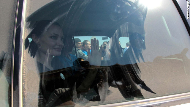 Jolie waves to the crowd as she arrived at Al Za'atri refugee camp on Wednesday.