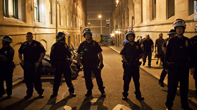 Police keep watch after monitoring an Occupy Wall Street march in New York City on Saturday.