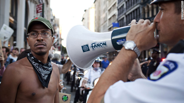 A police officer gives orders to Occupy Wall Street protesters on Saturday.