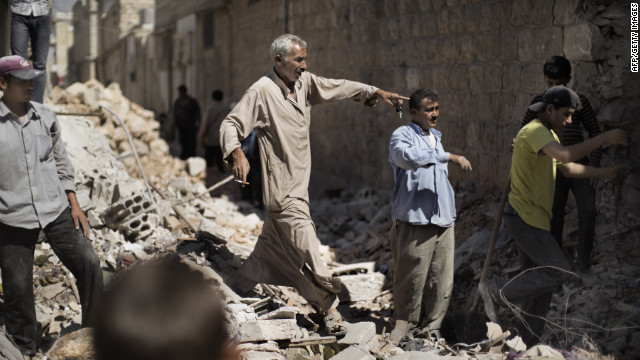 Syrian men sift through the rubble of houses in al-Bab on Saturday.