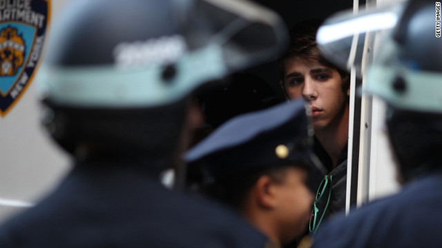 A protester looks out from a police van after being arrested on Monday.