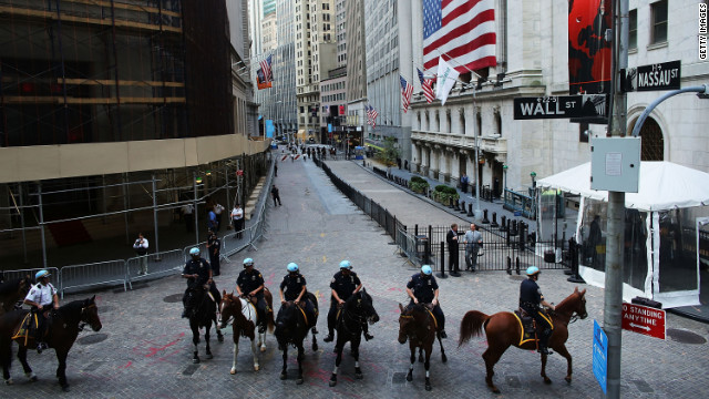 Police on horseback stand guard along Wall Street on Monday.