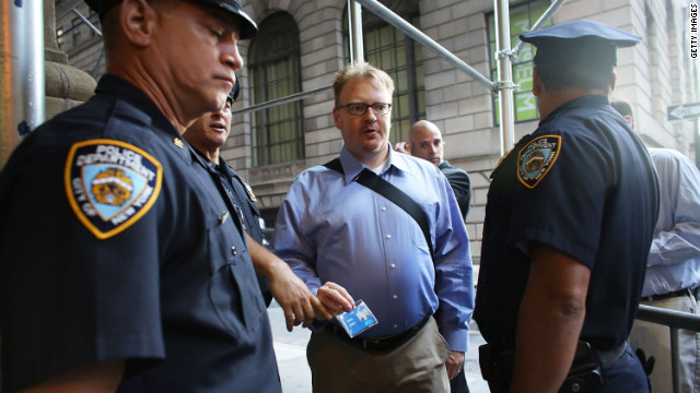 People have their identification checked at a police blockade along Wall Street on Monday.