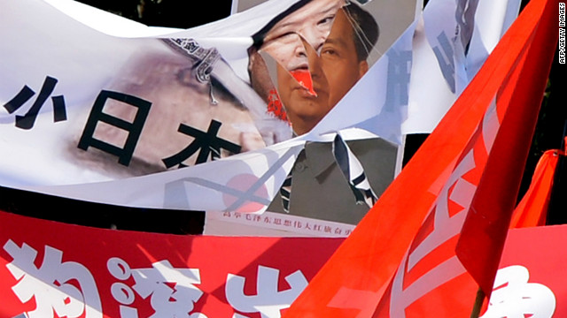 Protests swept through China as citizens expressed their anger at Japan's island purchase. A shredded banner shows Japanese Prime Minister Yoshihiko Noda beside a picture of Mao Zedong during protests in Beijing on September 16, 2012. 
