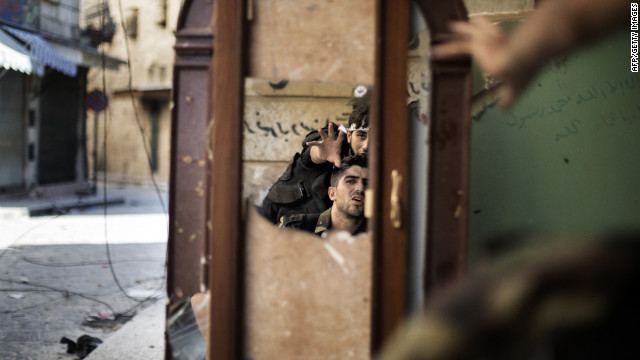 Free Syrian Army rebels use a mirror to scope out a nearby Syrian army outpost in Aleppo's Old City on Sunday, September 16.