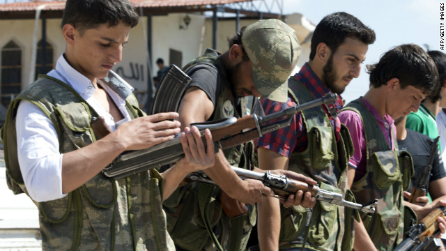 Volunteers for the Amr Ibn Al-Aass brigade load their rifles during training on the outskirts of Azaz, in northern Syria, on September 19.