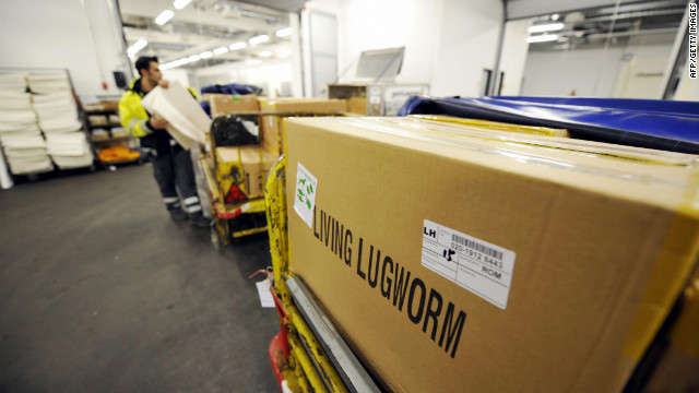 An airline staff member loads cases of living worms on a trailer at the Animal Lounge at Frankfurt's international airport. The lounge moves 300 tons of worms annually for use by fishermen around the world.