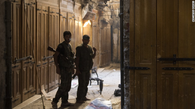 Syrian rebel fighters in position at a deserted market in Aleppo on Thursday.
