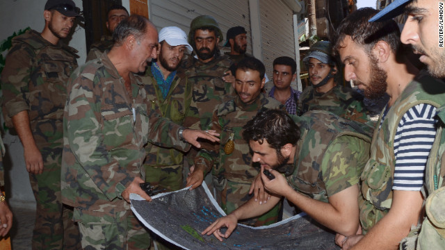 Syrian troops look at a map of the Suleiman al-Halabi neighborhood in Aleppo on Thursday.