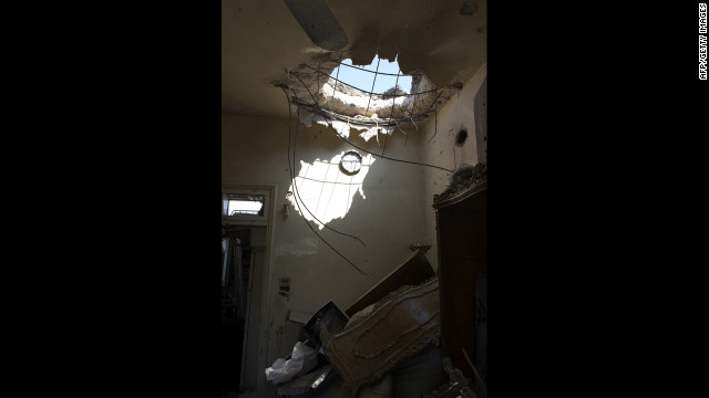 Friday's attack by Syrian forces leaves a hole in a house in Aleppo where a child was killed. 